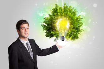 Young man presenting idea light bulb with green tree concept-1