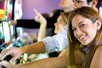 couple playing at the slot machines in a casino